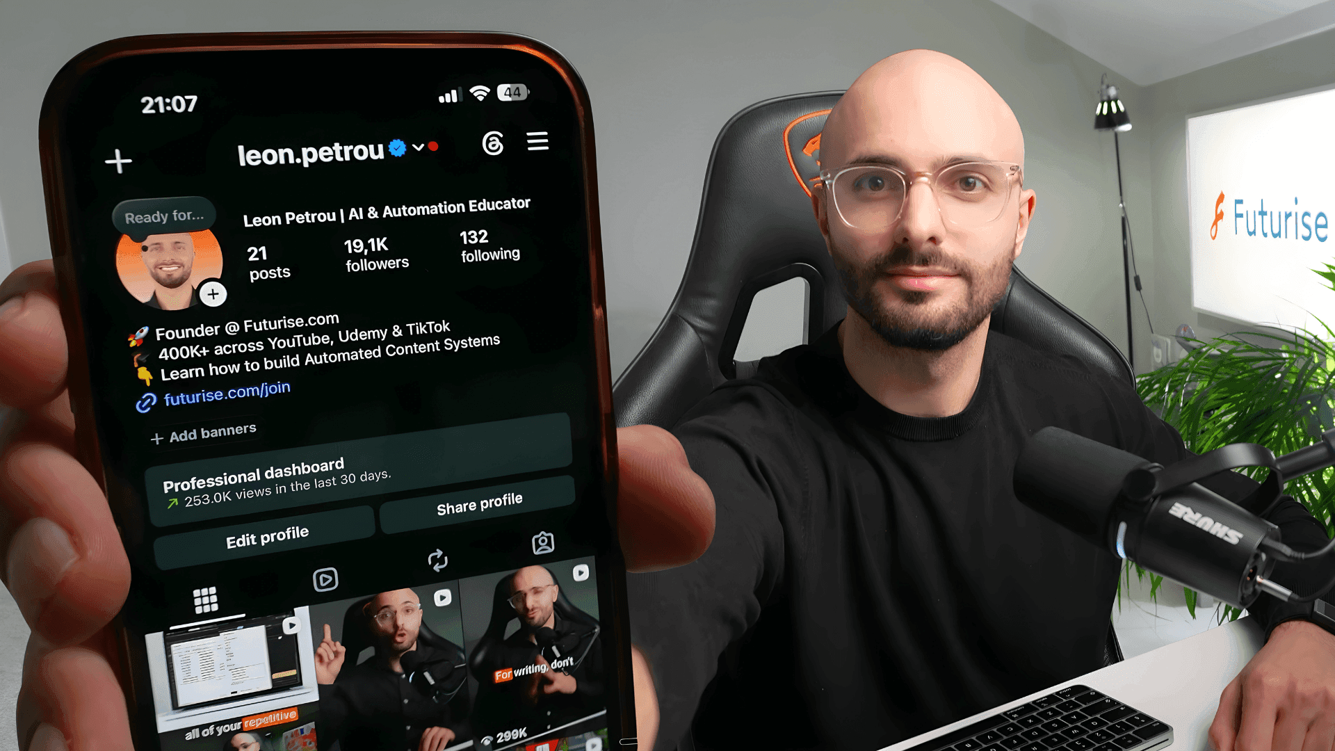 Leon Petrou smiling and holding his phone showing his Instagram following